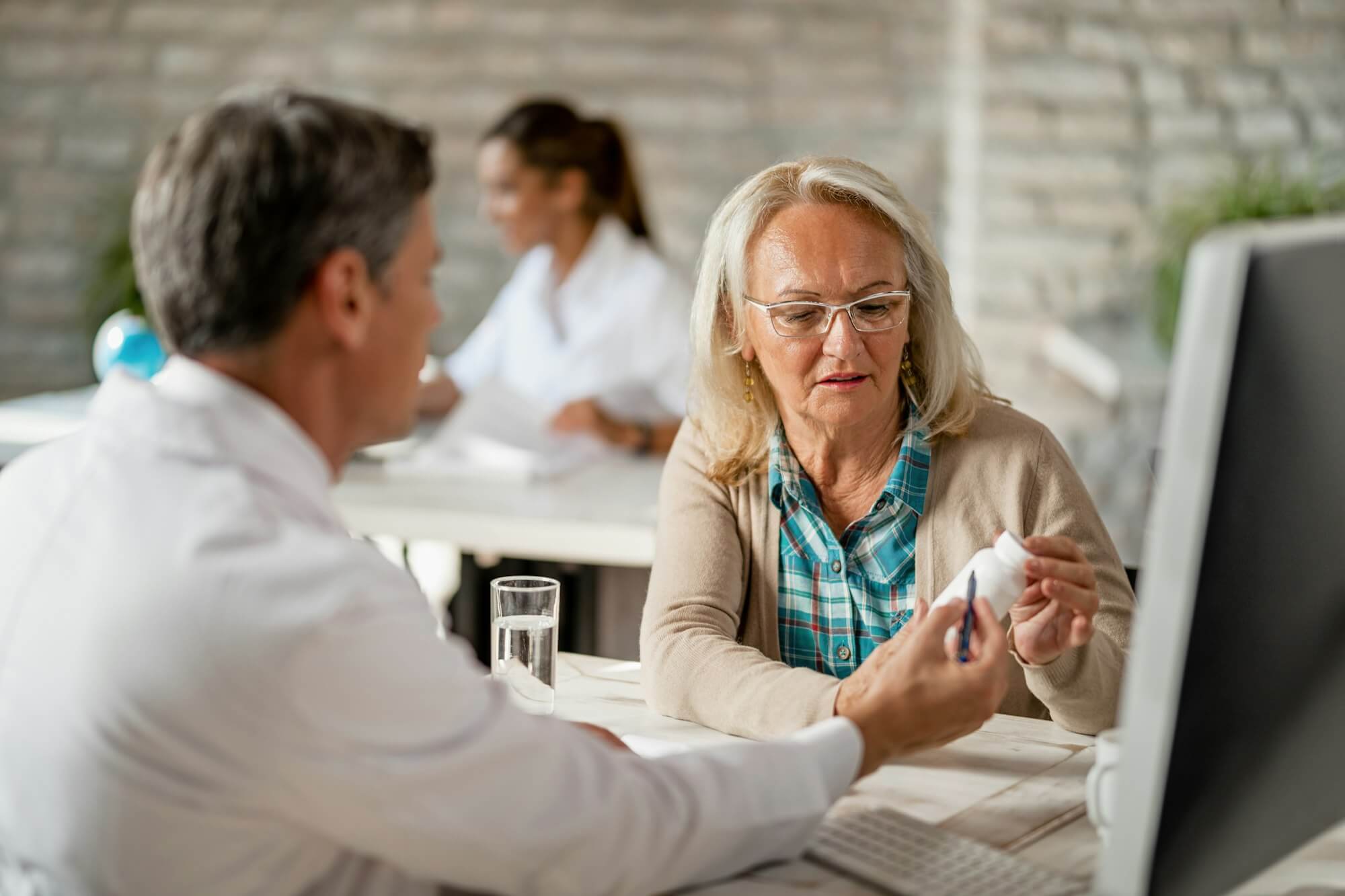 senior-woman-consulting-with-healthcare-worker-about-her-prescription-medicines-.jpg